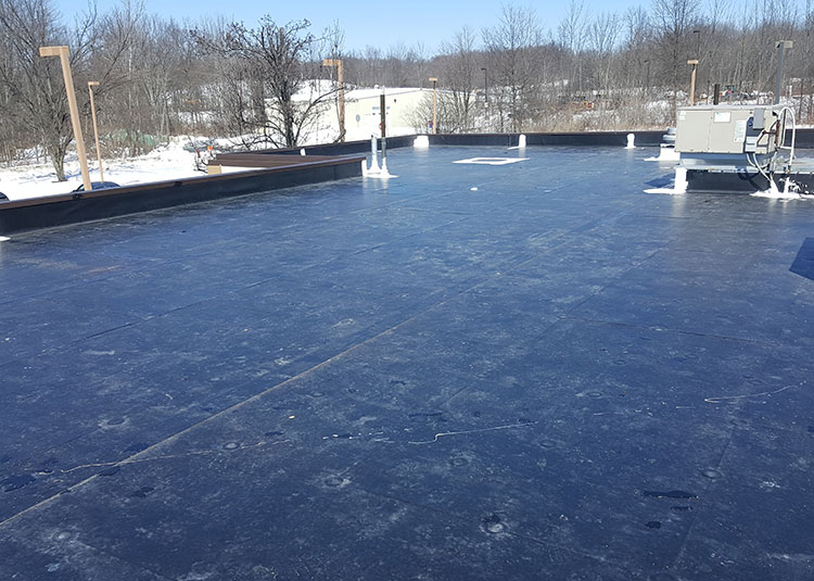 Polyglass roofing installation with energy-efficient cool roof technology.